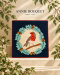 Rouge-gorge brodé au canevas dans une couronne de feuilles de chêne et de glands